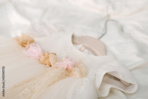 christening baby's dress hanging on a hanger
