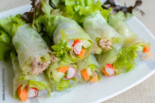 spring rolls with fresh vegetable on wooden table