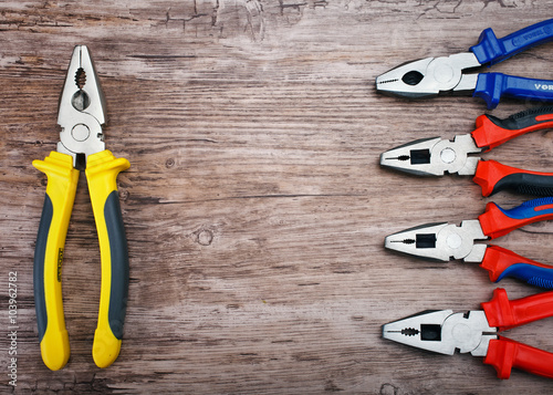 pliers on wooden background