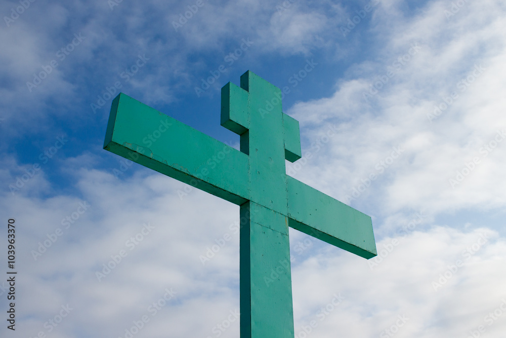 Green Orthodox cross on a background of blue sky