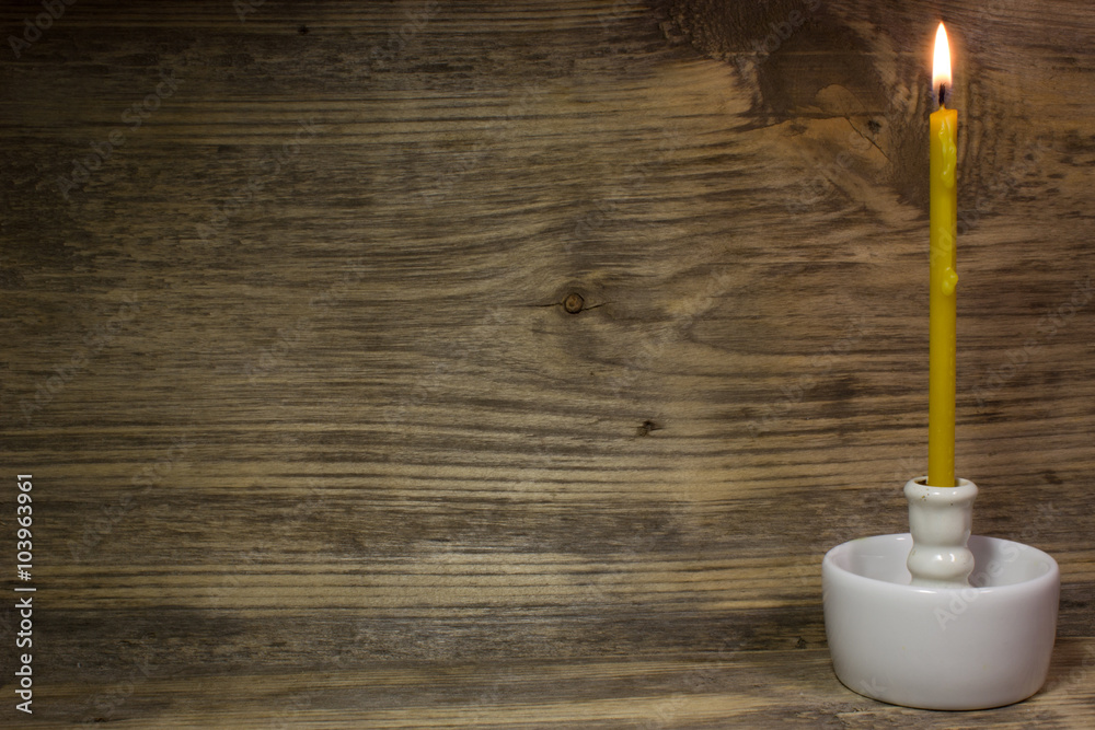Church burning candle on wooden background Church burning candle on wooden background