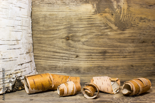 Rolls of birch Bark on wooden photo