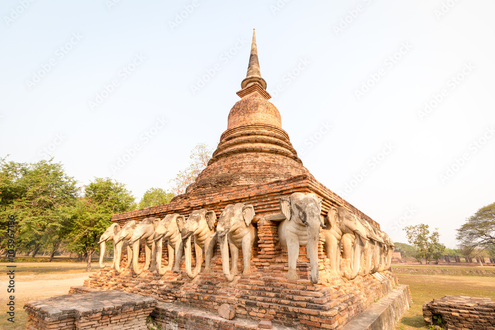 An ancient laterite/sandstone pagoda in Sukhothai's UNESCO world heritage historical park with elephant sculptures all around the four sides. The place is public property, no release document required