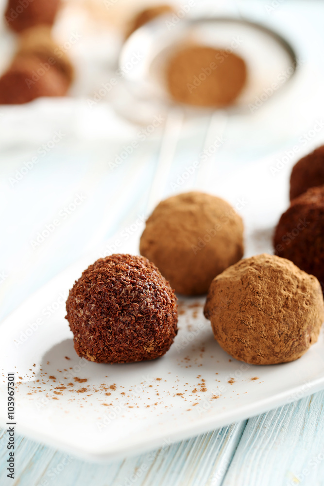 Sweet chocolate truffle on a blue wooden table