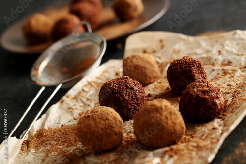 Sweet chocolate truffle on a black wooden table