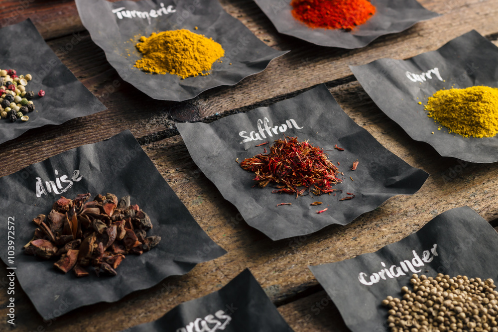 Colourful spices on wooden table