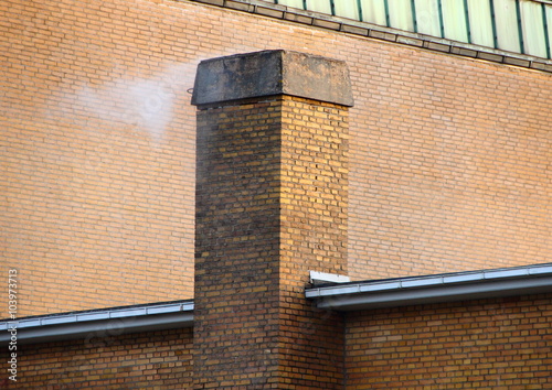 Smoking Chimney on Yellow Brick Tile Building