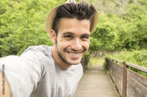 Handsome guy is taking a selfie outdoor - caucasian people