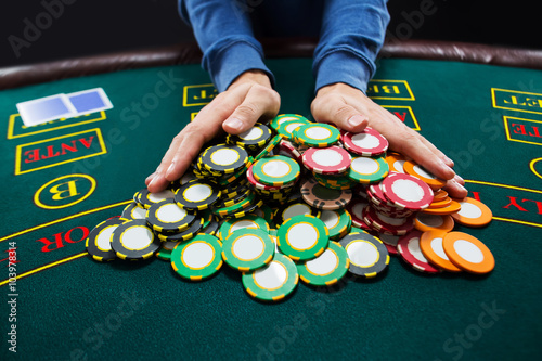 Poker player going all-in pushing his chips forward