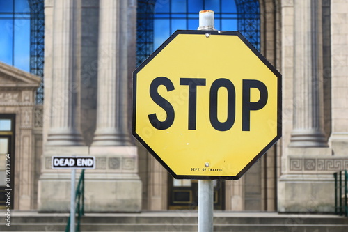 Yellow stop sign. Signs and symbols photo