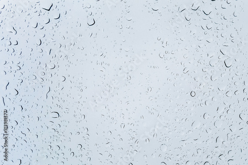 Photos Abstract drops through the glossy finish on a blue light background