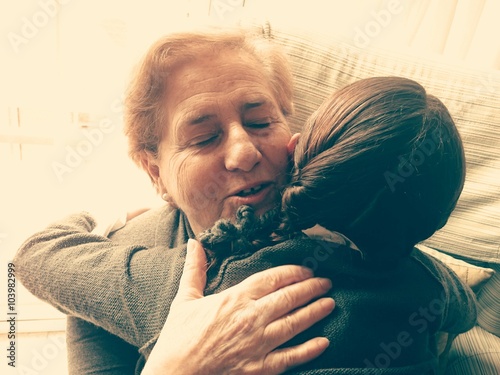 Nieta abrazando a su abuela photo