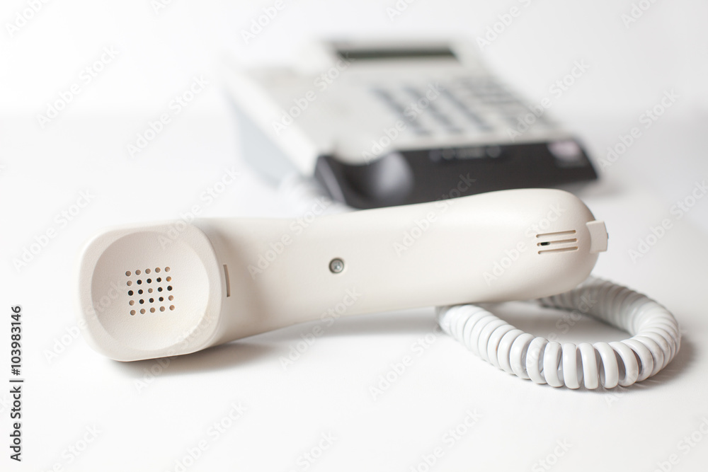 waiting for answer. Handset is on a white table. waiting for answer. Handset is on a white table.