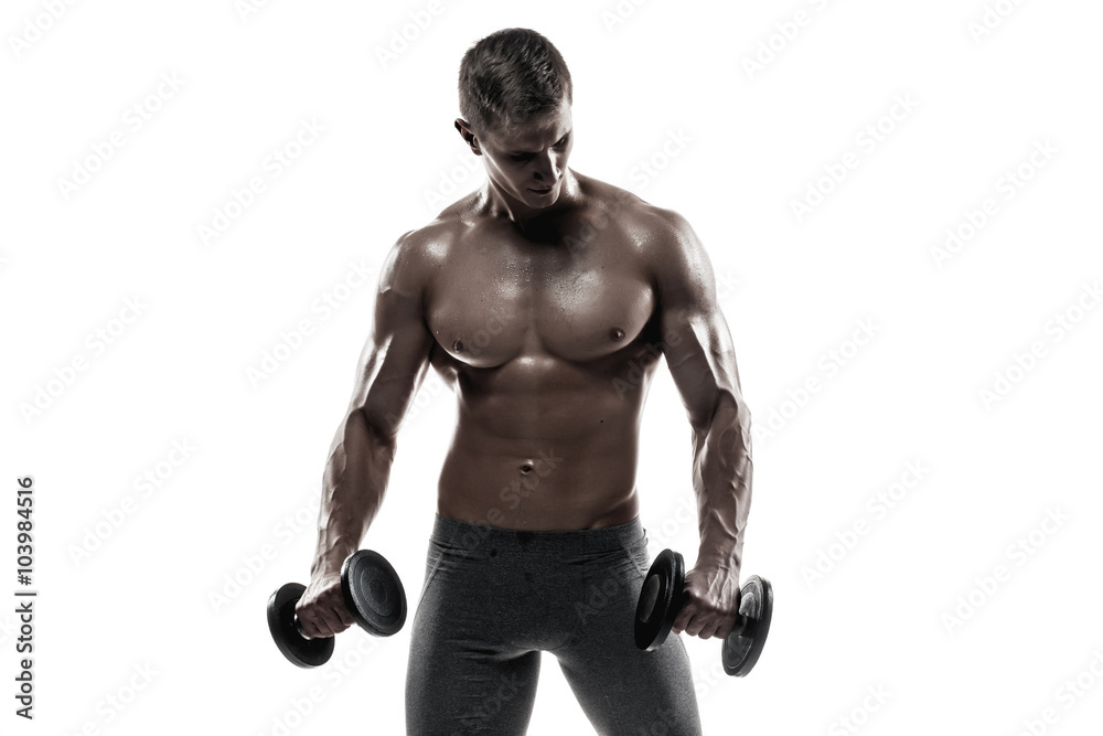 Athletic man showing muscular body and doing exercises with dumbbells Athletic man showing muscular body and doing exercises with dumbbells