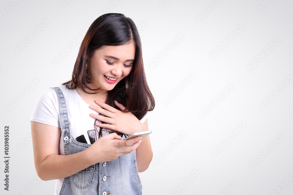 Girl checking phone with joy, isolated copy-space Girl checking phone with joy, isolated copy-space