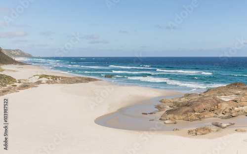 High Angle View of Lights Beach with White Sand and Rocks under a Clear Blue Sky on a Sunny Day