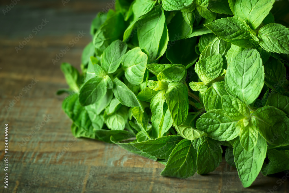 Fresh mint leaves on wooden background Fresh mint leaves on wooden background