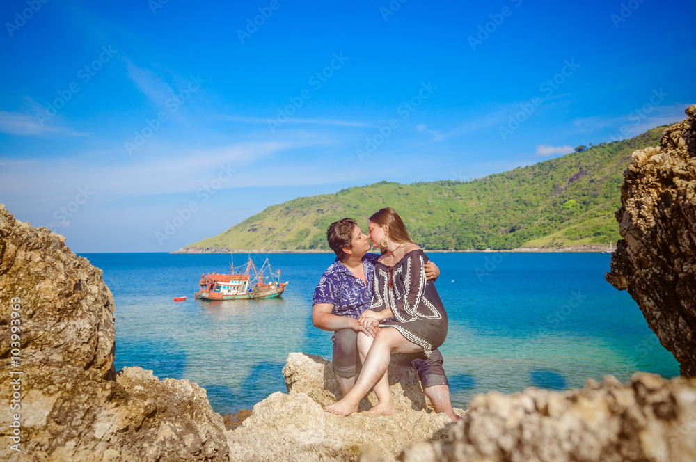 Joyful honeymoon couple playing on a beach in Phuket, Thailand Joyful honeymoon couple playing on a beach in Phuket, Thailand