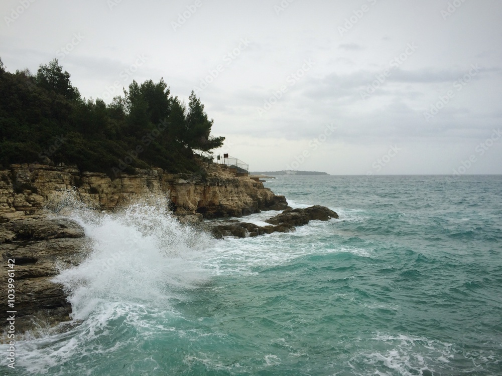 Strong waves hitting beach and splashing