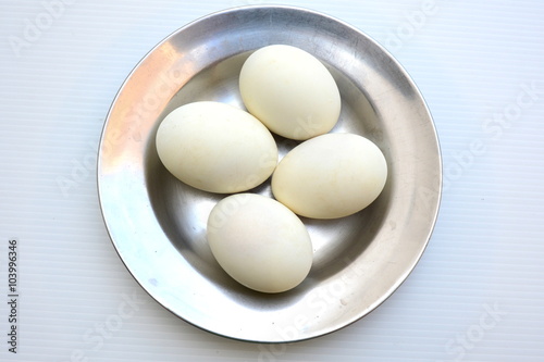 Salted duck eggs in dish on white background.