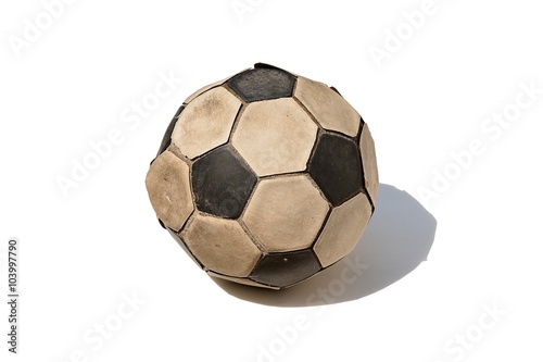 Dirty soccer ball under sunlight isolated on white background