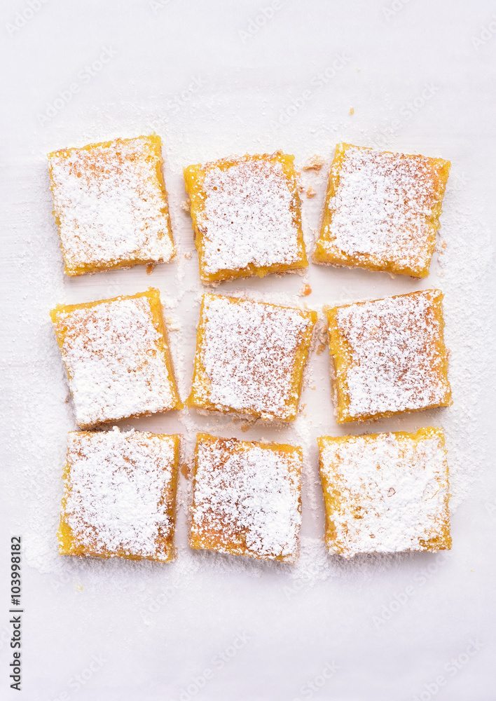 Dessert lemon bars over baking paper, top view