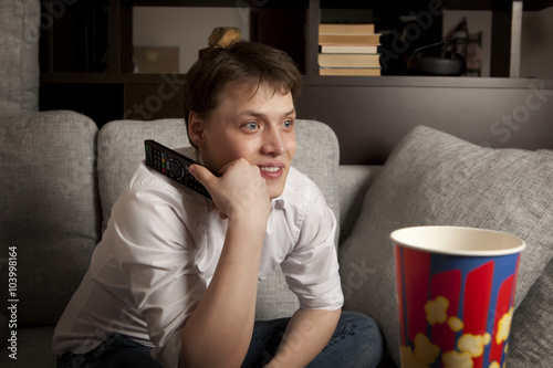 Young man with tv remote contro