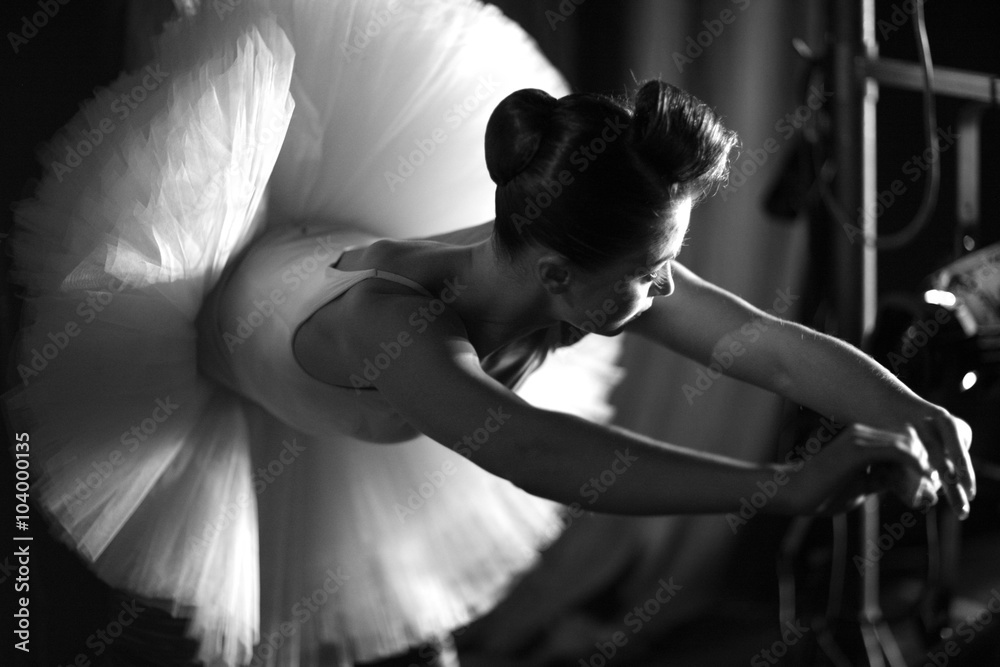 Naklejka premium Beautiful ballerina warming up on backstage