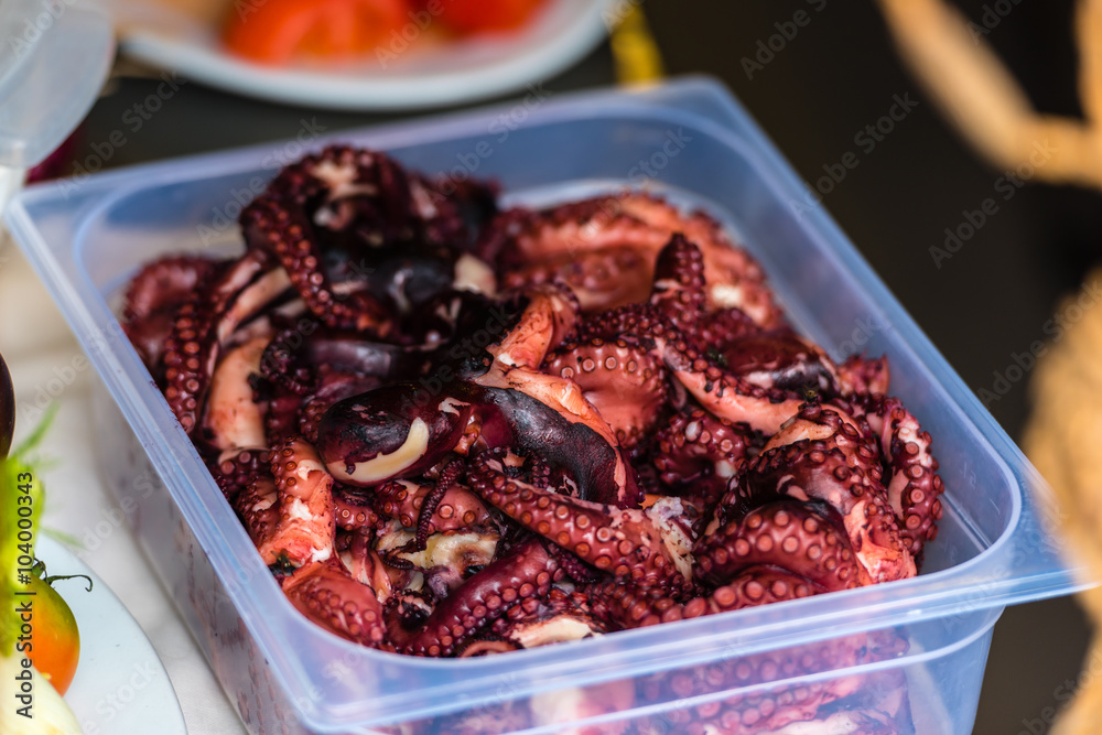 Cooked octopus parts in a box Cooked octopus parts in a box