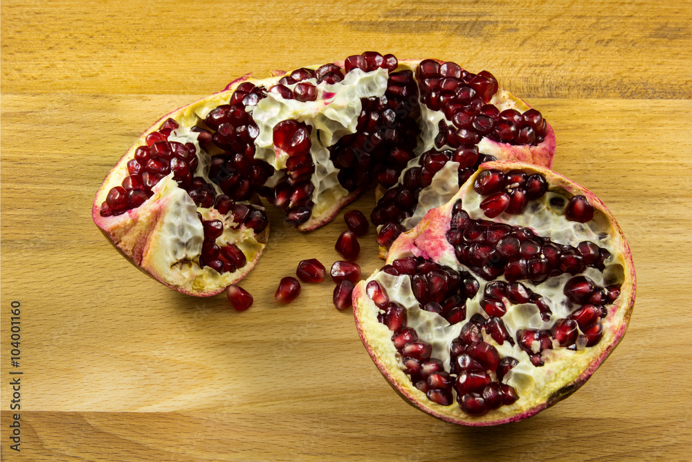 Ripe pomegranate fruit on wooden background Ripe pomegranate fruit on wooden background
