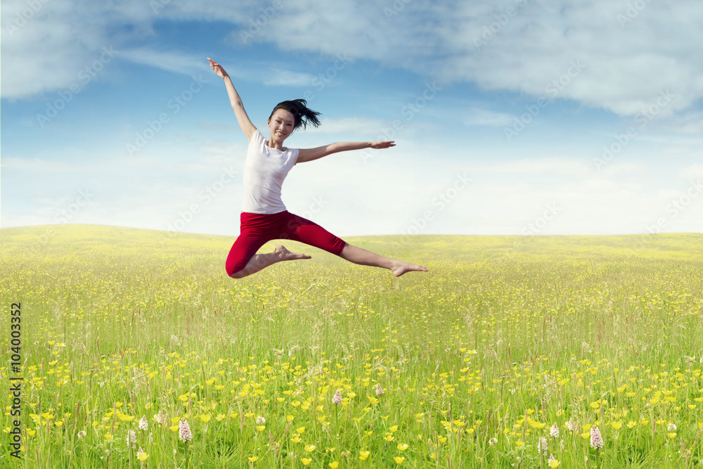 Joyful woman leaps at field in springtime Joyful woman leaps at field in springtime