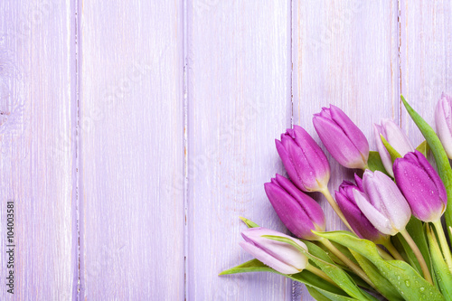 Fototapeta Naklejka Na Ścianę i Meble -  Purple tulips over wooden table