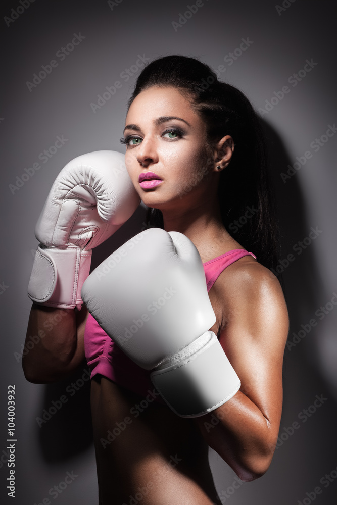 beautiful sexy boxer girl dressed in glove and staying in defense pose