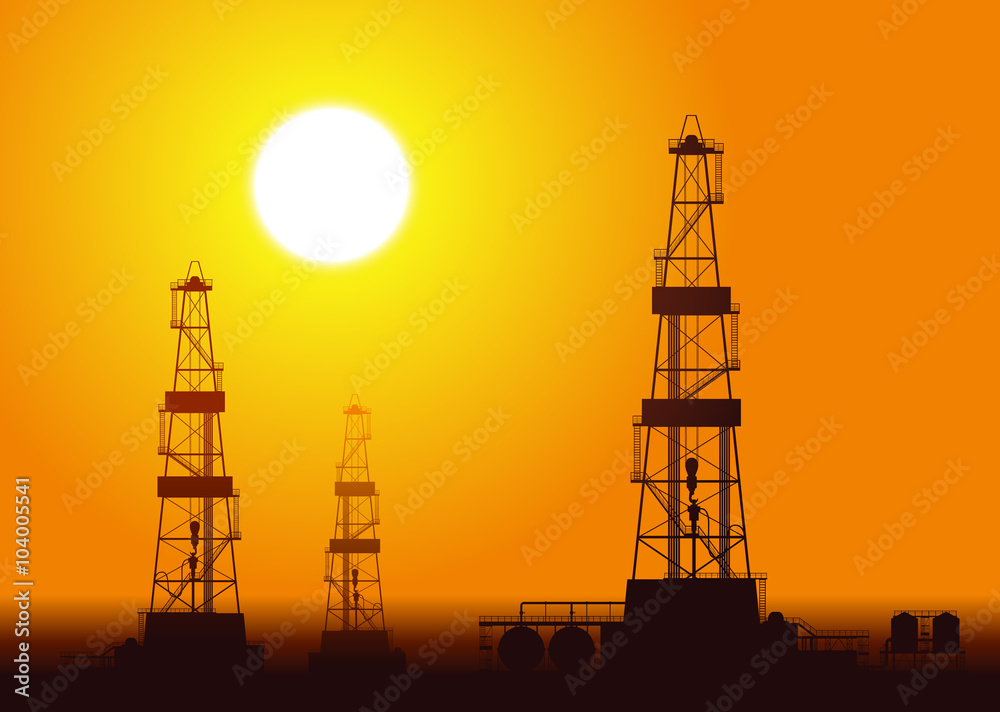 Oil rigs over sunset.