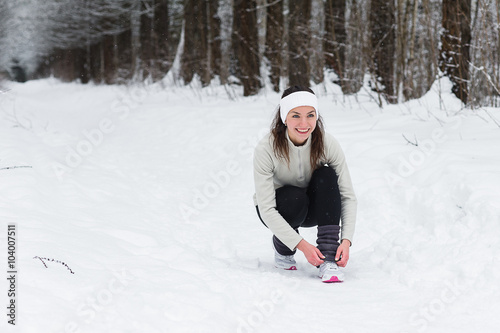 woman running jogging in the winter forest