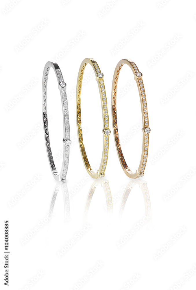 Set of three colored gold diamond bangle bracelets standing upri Set of three colored gold diamond bangle bracelets standing upri