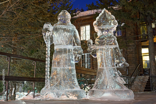 Snow maiden and Santa claus grandfather - Ice figures at night, in the street of Irkutsk, Siberia, Russia. Yhe pure ice is from Baikal lake. photo