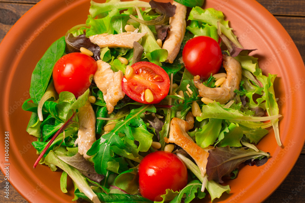 Fresh salad with chicken breast, arugula and tomato. Top view Fresh salad with chicken breast, arugula and tomato. Top view