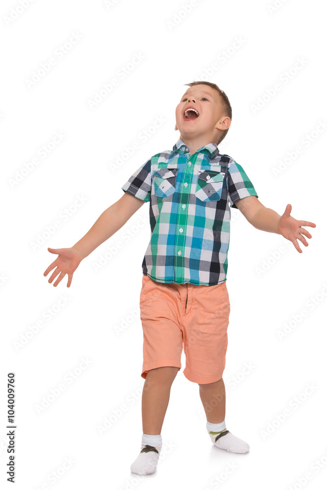Little boy in pink shorts and a summer shirt with short sleeves, gestures with hands and shouting with its mouth wide open - Isolated on white background Little boy in pink shorts and a summer shirt with short sleeves, gestures with hands and shouting with its mouth wide open - Isolated on white background