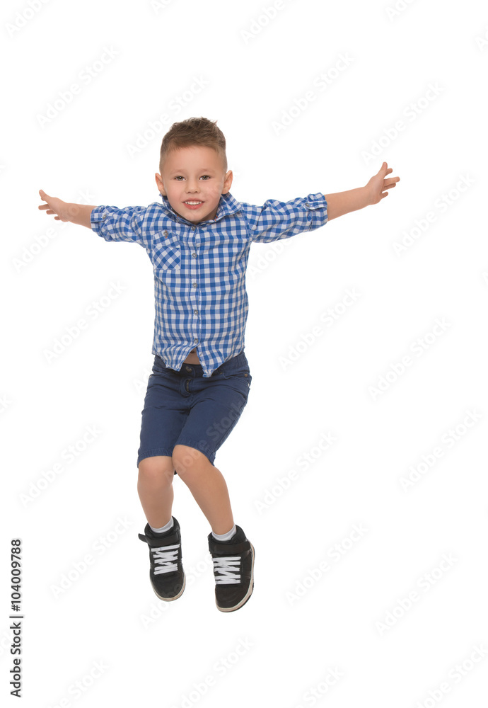Little boy in shirt and shorts jumps spread wide his arms - Isolated on white background Little boy in shirt and shorts jumps spread wide his arms - Isolated on white background