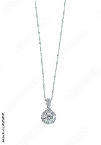 A beautiful diamond halo and white gold pendant dangles from a chain. Fine Jewelry necklace isolated on a white background with shadow and reflection