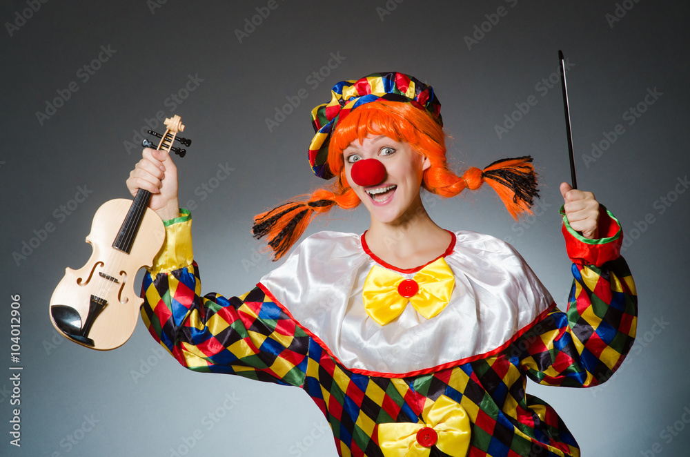 Clown in funny concept on dark background Clown in funny concept on dark background
