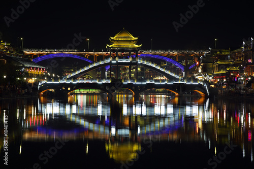 View of illuminated stone bridge in Fenghuang