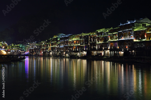 View of illuminated riverside houses in Fenghuang © estivillml
