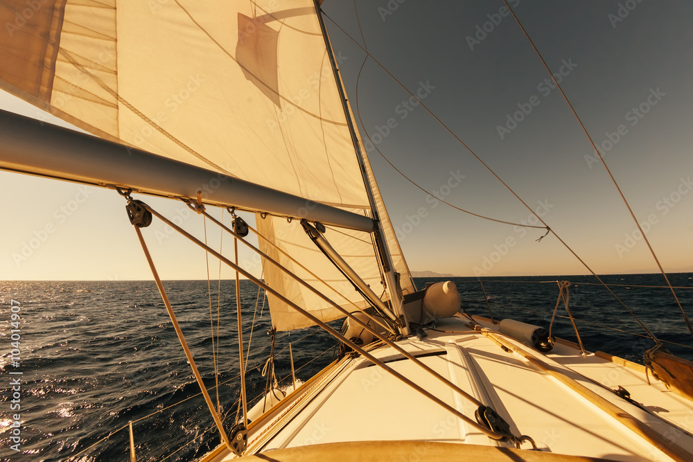 Sailing boat wide angle view in the sea at sunset