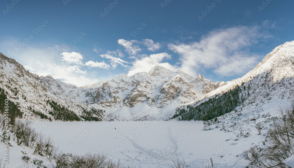 Sunny winter day in Polish Tatra mountains, frozen Morskie Oko lake