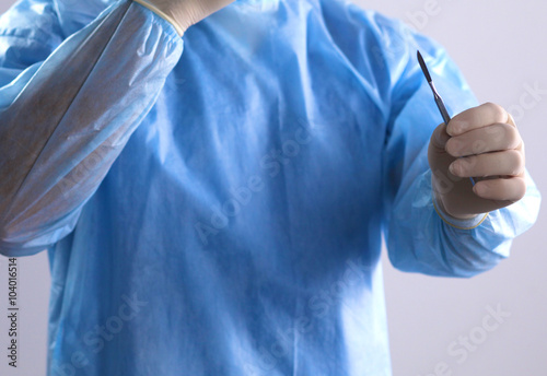 Man surgeon holds a scalpel in an operating room