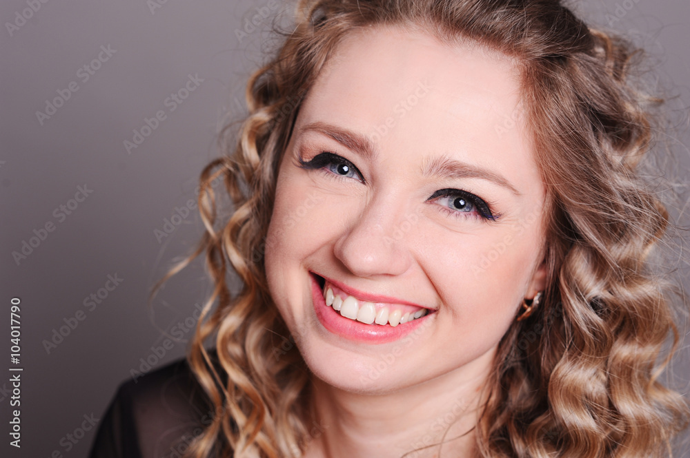 Laughing young woman close up. Beautiful girl 20-25 year old smiling over gray. Laughing young woman close up. Beautiful girl 20-25 year old smiling over gray.