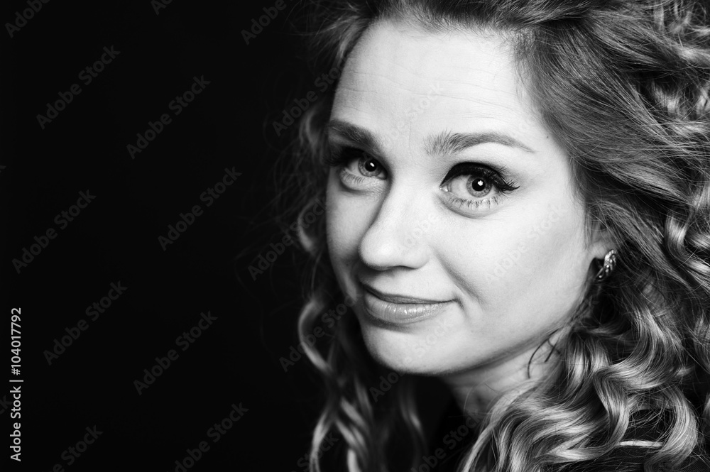 Fototapeta premium Black and white portrait of beautiful woman 20-25 year old. Smiling girl closeup. Young adults. 