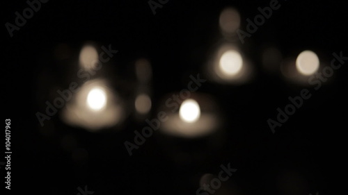 Burning candles in a glass on a dark background